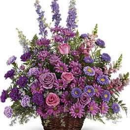 Basket arrangement of purple and pink flowers