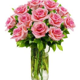 Pink roses arranged in a clear glass vase