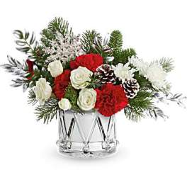 Red and white floral arrangement in a clear glass vase
