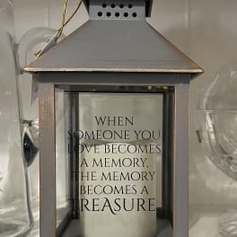 Decorative metal lantern with a memorial quote inside