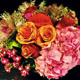 Bouquet of orange roses and pink hydrangeas with mixed filler flowers