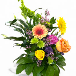 Mixed bouquet with gerbera daisies, roses, and colorful filler flowers