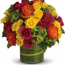 Bouquet of multicolored roses in a green glass vase