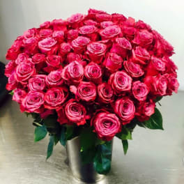 Large bouquet of hot pink roses in a metal vase