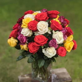 Bouquet of multicolored roses in a clear glass vase