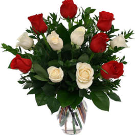 Red and white roses in a clear glass vase