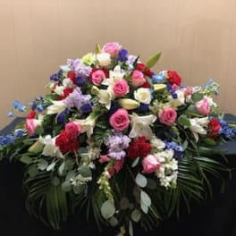 Large mixed floral arrangement with pink, white, red, and blue flowers