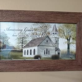 Framed wall art of a white church with the words Amazing Grace