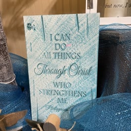 Decorative Christian sign with blue mesh ribbon and a small angel figure