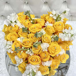 Heart-shaped bouquet of yellow roses and white flowers