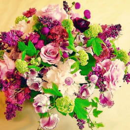 Bouquet of pink, purple, and white flowers with bright green accents