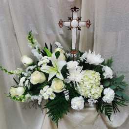 White floral spray with a decorative cross centerpiece