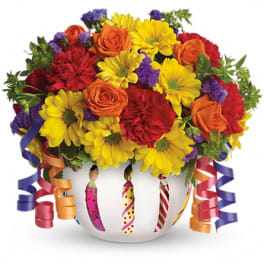 Colorful bouquet in a white vase with ribbon curls