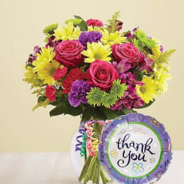 Mixed bouquet in a glass vase with a thank-you balloon