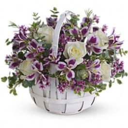 White basket of white roses and purple orchids
