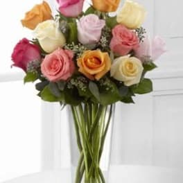 Bouquet of multicolored roses in a clear glass vase