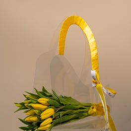 Yellow tulip bouquet in a clear acrylic handbag-shaped box