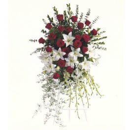 Standing spray of red roses and white lilies on a wire easel