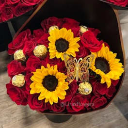 Bouquet of red roses with yellow sunflowers and gold chocolates in a black wrap