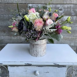 Mixed pink and white bouquet in a rustic wood-look container