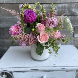 Pink and purple mixed bouquet in a white vase