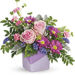 Pink roses and purple daisies in a lavender vase