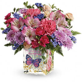 Mixed bouquet in a decorative butterfly-print gift bag