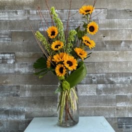 Sunflower arrangement in a clear glass vase