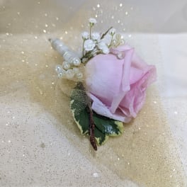 Pink rose boutonniere with pearl accents and gold tulle wrap