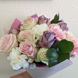 Bouquet of pink, white, and lavender roses with carnations