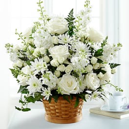 White flower arrangement in a woven basket