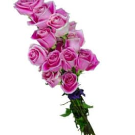 Bouquet of pink roses with a small purple accent flower