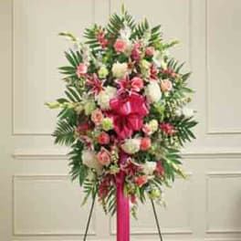 Standing floral spray with pink and white flowers on an easel