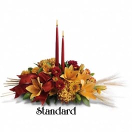 Autumn floral centerpiece with two red taper candles