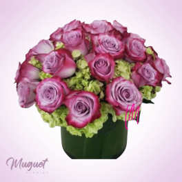 Pink and lavender roses arranged in a dark vase
