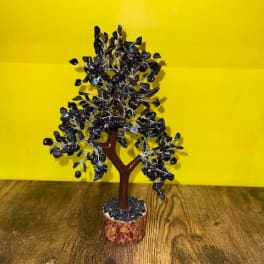 Small decorative tree with dark leaves in a round pot