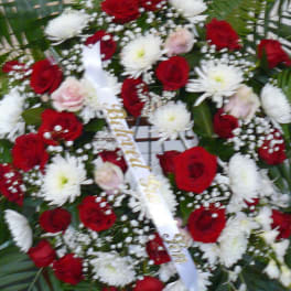 Red and white floral spray with roses and daisies
