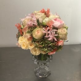 Pastel bouquet of roses and mixed blooms in a clear glass vase