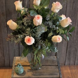 Bouquet of pale peach roses in a clear glass vase