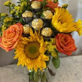 Bouquet of sunflowers, orange roses, and gold-wrapped chocolates