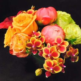 Bouquet of orange and pink roses with red-yellow orchids on a black background