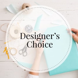 Designer’s Choice text over a craft table with paper and ribbon supplies