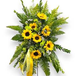 Standing sunflower spray with yellow ribbon on a metal easel