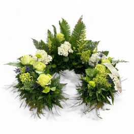 Circular floral wreath with white and lime-green blooms