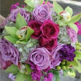 Bouquet of purple and pink roses with green orchids