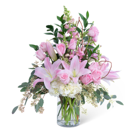 Pink roses and lilies in a clear glass vase