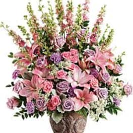 Pink and lavender floral arrangement in a decorative vase