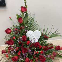 Red rose sympathy arrangement with a white angel heart plaque