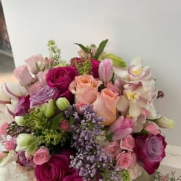 Bouquet of pink and purple roses with orchids and tulips
