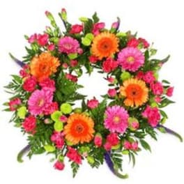 Circular wreath of pink and orange flowers on a white background